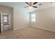 Cozy bedroom with neutral carpet and a large window bringing in natural light at 9074 W Runion Dr, Peoria, AZ 85382