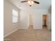 Spacious bedroom with plush carpeting, ceiling fan, and an ensuite closet at 9074 W Runion Dr, Peoria, AZ 85382