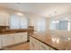 Bright kitchen featuring granite counters, white cabinets, a center island, and stainless appliances at 9074 W Runion Dr, Peoria, AZ 85382