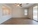 Open living area with laminate flooring and natural light, featuring a sliding glass door at 9074 W Runion Dr, Peoria, AZ 85382