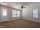 Bright living room with neutral walls, laminate flooring, and windows allowing natural light at 9074 W Runion Dr, Peoria, AZ 85382