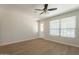 Bright living room with neutral walls, laminate flooring, and windows allowing natural light at 9074 W Runion Dr, Peoria, AZ 85382