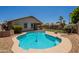 Inviting backyard pool with a unique shape, surrounded by desert landscaping and privacy fencing at 9074 W Runion Dr, Peoria, AZ 85382