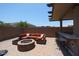 Backyard patio with an outdoor kitchen, lounge area, and a fire pit, perfect for outdoor entertaining at 9337 W Medlock Dr, Glendale, AZ 85305
