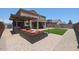 Spacious backyard with built-in outdoor kitchen, covered patio, comfortable seating, and well-maintained lawn at 9337 W Medlock Dr, Glendale, AZ 85305