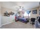 Themed bedroom with a ceiling fan, wall decor, and a comfortable bed at 9337 W Medlock Dr, Glendale, AZ 85305