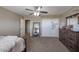 Bright bedroom with a large mirror, ceiling fan, and carpet flooring at 9337 W Medlock Dr, Glendale, AZ 85305