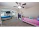Bright bedroom featuring carpet, a ceiling fan, and neutral paint, plus an attached bedroom at 9337 W Medlock Dr, Glendale, AZ 85305