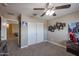 Well-lit bedroom features double doors, carpet flooring, and neutral paint at 9337 W Medlock Dr, Glendale, AZ 85305