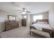 Cozy bedroom featuring a ceiling fan, natural light, and carpet flooring at 9337 W Medlock Dr, Glendale, AZ 85305