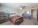Comfortable bedroom with ceiling fan, carpeted floor, and rustic wood furnishings at 9337 W Medlock Dr, Glendale, AZ 85305