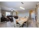 Elegant dining area flowing into the living room, featuring tile flooring and stylish furnishings at 9337 W Medlock Dr, Glendale, AZ 85305
