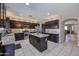 Well-equipped kitchen with dark cabinetry, a central island, and stainless steel appliances at 9337 W Medlock Dr, Glendale, AZ 85305