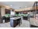Well-lit kitchen boasts granite countertops, stainless steel appliances, and a kitchen island with bar seating at 9337 W Medlock Dr, Glendale, AZ 85305