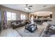 Comfortable living room with tile floors, seamlessly flowing into the modern kitchen and dining area at 9337 W Medlock Dr, Glendale, AZ 85305