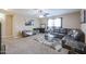 Cozy living room with plush gray sofa, glass coffee table, carpet, and ample natural light at 9337 W Medlock Dr, Glendale, AZ 85305