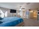 Spacious main bedroom featuring carpeted floors, a ceiling fan, and ensuite bathroom access at 9337 W Medlock Dr, Glendale, AZ 85305
