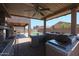 This covered outdoor kitchen features a grill, sink, counter space and backyard views at 9337 W Medlock Dr, Glendale, AZ 85305