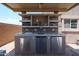 Covered outdoor kitchen with built-in sink, refrigerator, counter space, and tiled backsplash at 9337 W Medlock Dr, Glendale, AZ 85305