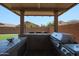 Covered outdoor kitchen featuring a grill, counter space, and plenty of room to entertain at 9337 W Medlock Dr, Glendale, AZ 85305