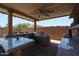 This outdoor kitchen has a built-in stainless steel grill, counterspace, and a fan for hot days at 9337 W Medlock Dr, Glendale, AZ 85305