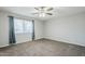 Relaxing bedroom with plush carpet, soft window lighting, and a modern ceiling fan at 1066 E 7Th Pl, Mesa, AZ 85203