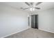 A bedroom with ceiling fan, carpet, neutral walls, and modern doors to provide comfort and privacy at 1066 E 7Th Pl, Mesa, AZ 85203