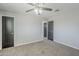 Spacious bedroom with ceiling fan, neutral walls, carpet, and modern doors provides comfort and style at 1066 E 7Th Pl, Mesa, AZ 85203