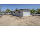 Exterior view of the house with a neutral color, simple landscaping and a covered patio in the backyard at 1066 E 7Th Pl, Mesa, AZ 85203