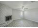 Well-lit living room featuring a painted brick fireplace and sleek, updated flooring at 1066 E 7Th Pl, Mesa, AZ 85203