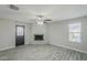 Inviting living room with a painted brick fireplace, updated flooring, and natural light at 1066 E 7Th Pl, Mesa, AZ 85203