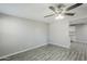 Bright living room with light-colored flooring, ceiling fan, and access to the kitchen area at 1066 E 7Th Pl, Mesa, AZ 85203