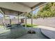 Covered patio with furniture and artificial turf creates a welcoming outdoor space at 1066 E 7Th Pl, Mesa, AZ 85203