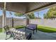 Covered patio with stylish seating, privacy wall, and lush landscaping perfect for relaxation at 1066 E 7Th Pl, Mesa, AZ 85203