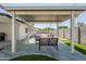 A covered patio has a seating area with purple striped cushions and a concrete floor at 1066 E 7Th Pl, Mesa, AZ 85203