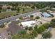 Aerial view of a single-story house with desert landscaping, large driveway, outdoor seating, and fenced pool at 11041 N Hayden Rd, Scottsdale, AZ 85260