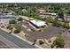 Aerial view of a single-story home with a modern style, desert landscaping, circular driveway, and palm trees at 11041 N Hayden Rd, Scottsdale, AZ 85260
