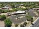 Aerial view of a single-story home with a modern style, circular driveway, desert landscaping, and a fenced pool at 11041 N Hayden Rd, Scottsdale, AZ 85260