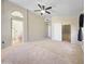 Spacious bedroom with a ceiling fan, walk-in closet and bathroom access at 12770 W Alvarado Rd, Avondale, AZ 85392