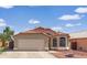 Charming single-story home with a red-tiled roof, neutral stucco and a well-maintained front yard at 12770 W Alvarado Rd, Avondale, AZ 85392