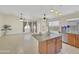 Spacious kitchen with granite countertops, tile flooring, stainless steel appliances and a kitchen island at 12770 W Alvarado Rd, Avondale, AZ 85392