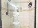 Close-up of a walk-in shower with tile walls, a rainfall showerhead, and glass enclosure at 12770 W Alvarado Rd, Avondale, AZ 85392