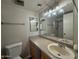 Neutral bathroom featuring tiled shower, dual mirrors, vanity and sink at 131 N Higley Rd # 215, Mesa, AZ 85205