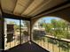 Cozy carpeted patio with an archway overlooking community green space at 131 N Higley Rd # 215, Mesa, AZ 85205