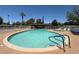 Community pool surrounded by lounge chairs with an adjacent spa at 131 N Higley Rd # 215, Mesa, AZ 85205