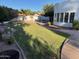 Lush backyard featuring well-manicured lawn, mature trees, and a glimpse of the property's exterior at 1454 E Calle De Arcos --, Tempe, AZ 85284