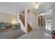Welcoming foyer with staircase, neutral tones, and tile flooring, seamlessly connecting living spaces at 1454 E Calle De Arcos --, Tempe, AZ 85284