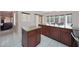 Kitchen area with dark wood cabinets, granite countertops, breakfast bar, and tile floors at 1454 E Calle De Arcos --, Tempe, AZ 85284