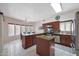 Bright kitchen with a center island, stainless steel appliances, granite countertops, and an eat-in area at 1454 E Calle De Arcos --, Tempe, AZ 85284