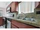 Kitchen with granite countertops, stainless steel appliances, and a double sink at 1454 E Calle De Arcos --, Tempe, AZ 85284
